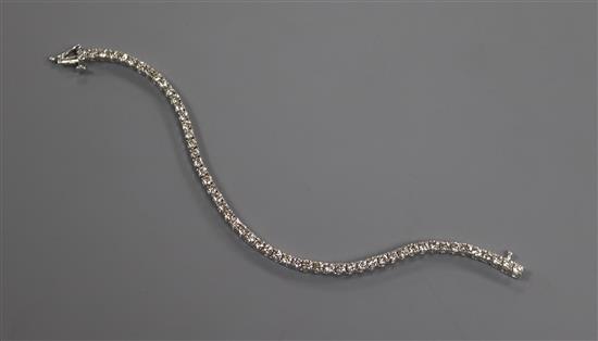 An 18ct white gold and diamond line bracelet, set with fifty four stones with an estimated total weight of 5.00cts, 17.5cm.